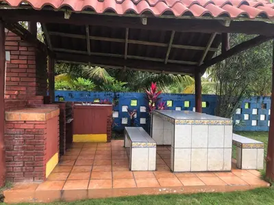 a patio with benches under a gazebo at Casa Rector - Beach House Rental in El Roble
