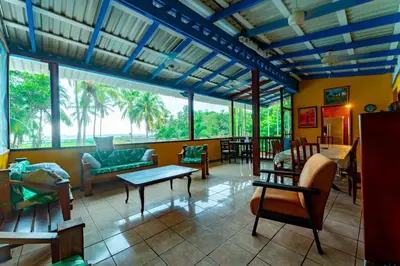 a living room filled with furniture and a large window at Casa Rector - Beach House Rental in El Roble