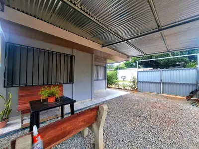 a patio with a bench and a building at Casa Jako's in Uvita