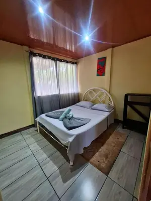 a bedroom with a bed in a room with a window at Casa Jako's in Uvita