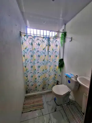 a bathroom with a shower curtain with a toilet at Casa Jako's in Uvita