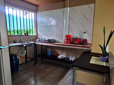 a kitchen with a counter and a sink in a room at Casa Jako's in Uvita