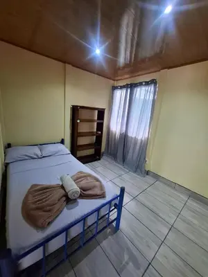 a bedroom with a bed with a towel on it at Casa Jako's in Uvita