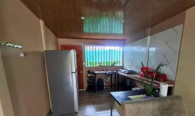 a kitchen with a refrigerator and a table in it at Casa Jako's in Uvita