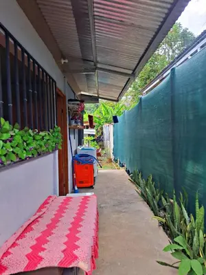 a patio with a bench and a fence and plants at Casa Jako's in Uvita