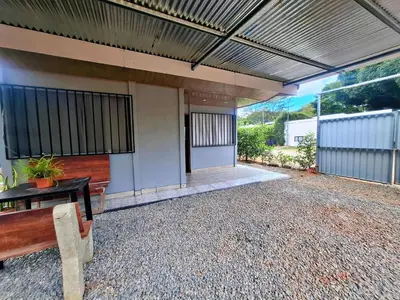 an outside view of a house with a bench at Casa Jako's in Uvita