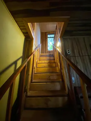 a flight of stairs in a house with a window at Makena Rancho in Monteverde Costa Rica