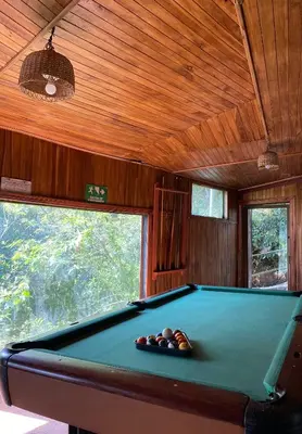 a billiard room with a pool table in a house at Makena Rancho in Monteverde Costa Rica