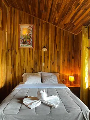 a bedroom with a bed with two towels on it at Makena Rancho in Monteverde Costa Rica