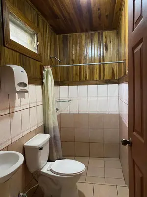 a bathroom with a toilet and a sink at Makena Rancho in Monteverde Costa Rica