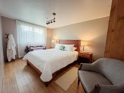 a bedroom with a bed and a couch and a chair at Casa las Luciernagas in Bajos del Toro