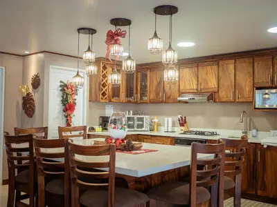 a kitchen with wooden cabinets and a table with chairs at Casa las Luciernagas in Bajos del Toro