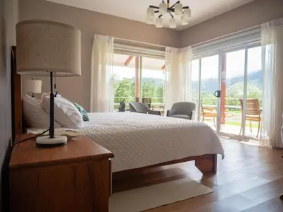 a bedroom with a bed and a table with a lamp at Casa las Luciernagas in Bajos del Toro