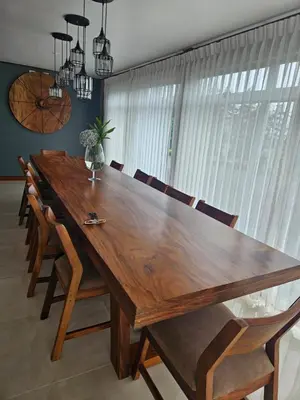 a dining room table with chairs and a large wooden table at Casa las Luciernagas in Bajos del Toro