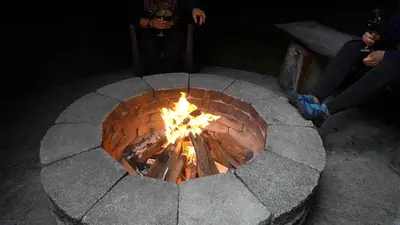 a brick fire pit with people sitting around it at Casa las Luciernagas in Bajos del Toro