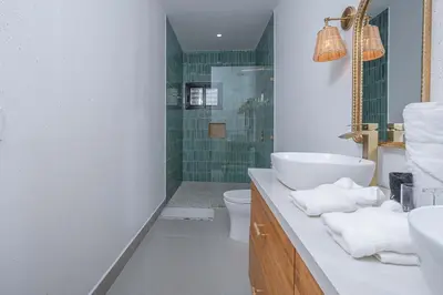 a bathroom with a sink and a toilet and a shower at CASA AZUL - Luxury Beachfront Mansion in Potrero