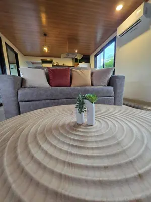a circular table in a living room with a couch at Casa Brisa Moderna, para 8 personas in Jabillos