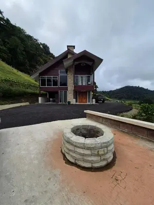 a house with a fire pit in front of it at Casa Hortensias in Bajos del Toro
