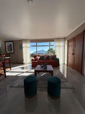 a living room with a couch and a table at Casa Hortensias in Bajos del Toro