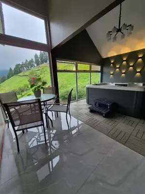 a kitchen and dining room with a table and a fireplace at Casa Hortensias in Bajos del Toro
