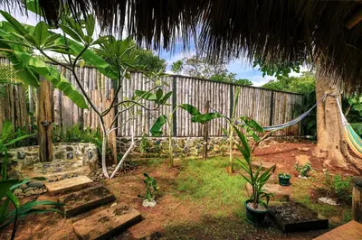 a garden with a fence and some plants in the yard at Flor y Bambu in Playa Grande