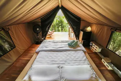 a tent with a bed in the middle of a room at Flor y Bambu in Playa Grande