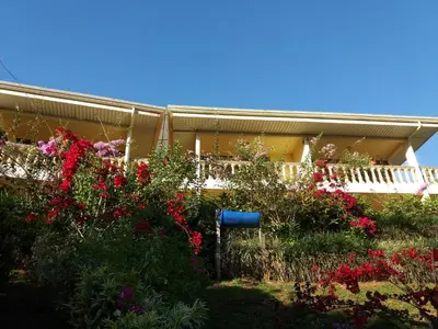 a house with a bunch of flowers in front of it at La Princesa Hotel in San Isidro
