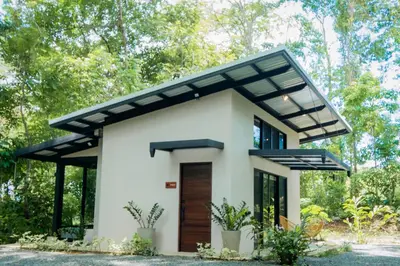 a rendering of a small white house with a black roof at Selva Color - Forest & Beach EcoLodge in Quebrada Ganado