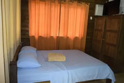 a bedroom with a bed with a towel on it at Villas Maria Luisa in Uvita