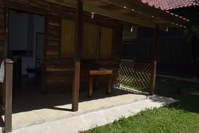a wooden cabin with a table on a porch at Villas Maria Luisa in Uvita
