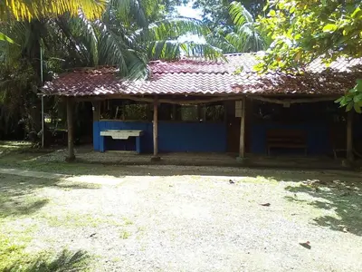 a small blue building with a red roof at Villas Maria Luisa in Uvita