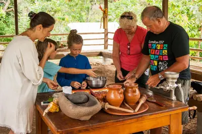 a group of people standing around a table with pottery at Finca Luna Nueva Lodge in Fortuna