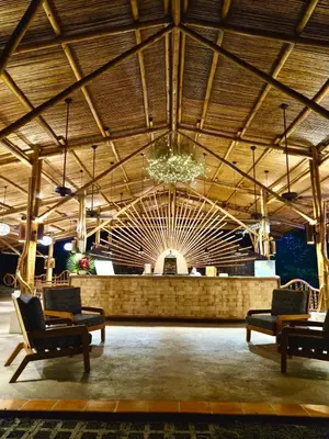 a large lobby with chairs and a large ceiling at Finca Luna Nueva Lodge in Fortuna