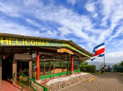 a flag is flying in front of a restaurant at Hotel y Puentes Colgantes Heliconias Rainforest Lodge in Bijagua