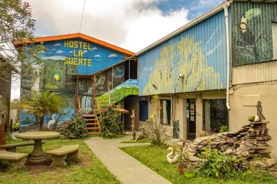 a building with a mural on the side of it at Hostel La Suerte in Monteverde Costa Rica