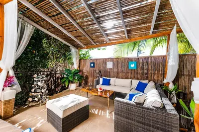an outdoor living room with a couch and chairs at Villa Nautilus in Tamarindo