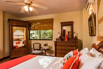 a bedroom with a bed and a dresser and a mirror at Villa Nautilus in Tamarindo