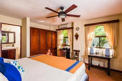 a bedroom with a bed and a ceiling fan at Villa Nautilus in Tamarindo