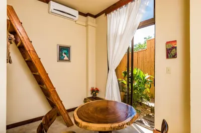 a room with a wooden table and a window at Villa Nautilus in Tamarindo