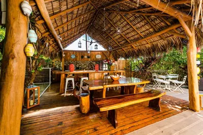 an outdoor patio with a table and a bench at Villa Nautilus in Tamarindo