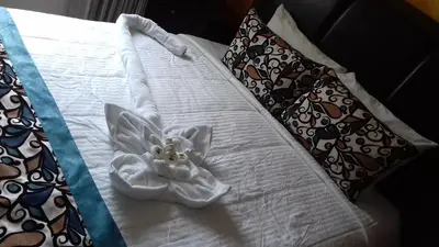 a white angel made out of towels on a bed at Hotel Vista De Golf, San Jose Aeropuerto, Costa Rica in San José
