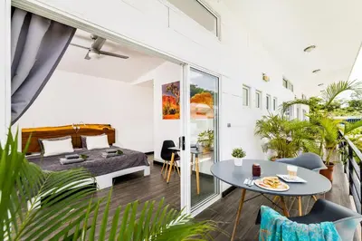 a bedroom with a bed and a table at In the Shade Hotel - Coworking - 300Mbit - Adults Only in Tamarindo