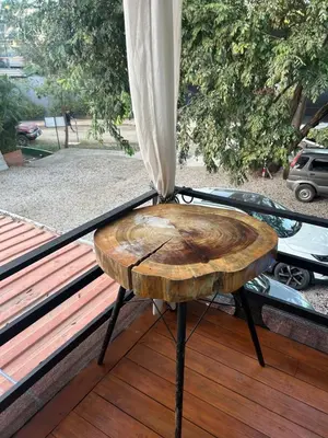 a wooden stool sitting on top of a porch at In the Shade Hotel - Coworking - 300Mbit - Adults Only in Tamarindo