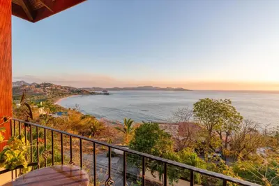 a view of the ocean from a balcony at Stunning Villa with Oceanview, Private Pool, Soaking Tub & Picturesque Balcony in Playa Flamingo