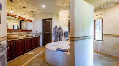 a bathroom with a large tub in the middle at Stunning Luxury Mansion in Playa Flamingo with Six Bedrooms and Beachfront Access in Playa Flamingo