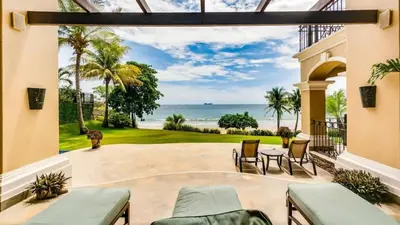 a patio with a view of the ocean at Stunning Luxury Mansion in Playa Flamingo with Six Bedrooms and Beachfront Access in Playa Flamingo