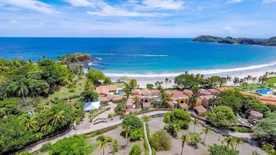 an aerial view of a resort with the beach at Stunning Luxury Mansion in Playa Flamingo with Six Bedrooms and Beachfront Access in Playa Flamingo
