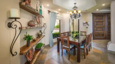 a dining room with a wooden table and chairs at Stunning Luxury Mansion in Playa Flamingo with Six Bedrooms and Beachfront Access in Playa Flamingo