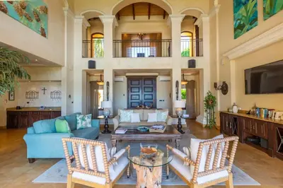 a living room with a couch and a table at Elegant Mediterranean-Style Mansion with Beachfront Views and Private Infinity Pool in Playa Flamingo