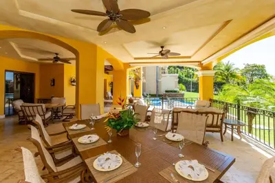 a dining room with a table and chairs at Elegant Mediterranean-Style Mansion with Beachfront Views and Private Infinity Pool in Playa Flamingo